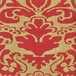 Red and gold damask-patterned cocktail napkin with ornate scroll detailing