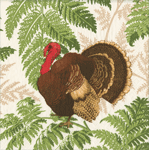 Caspari cocktail napkin featuring silhouetted turkey in red and brown tones, framed by lush green fern fronds