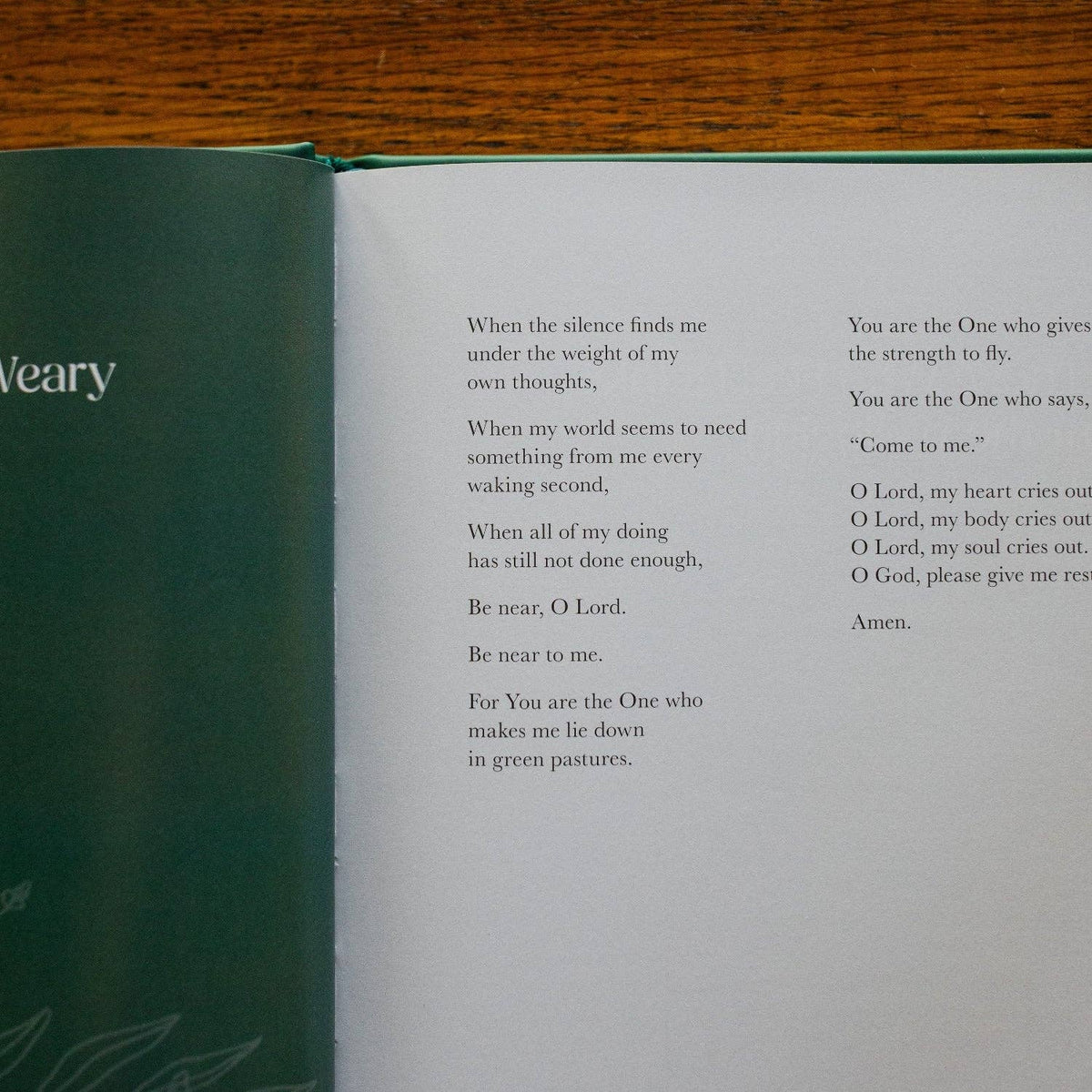 Draw Near to God prayer book open to green-bound pages with printed prayers and devotional text on cream paper