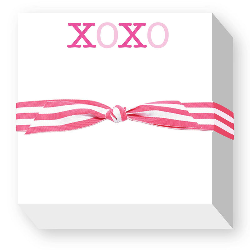 Pink and white notepad with "XOXO" text in hot pink and pale pink lettering, tied with a striped pink and white grosgrain ribbon bow
