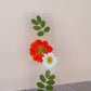 Pressed floral bookmark with red dahlia, white daisy, and green leafy stem on clear resin card