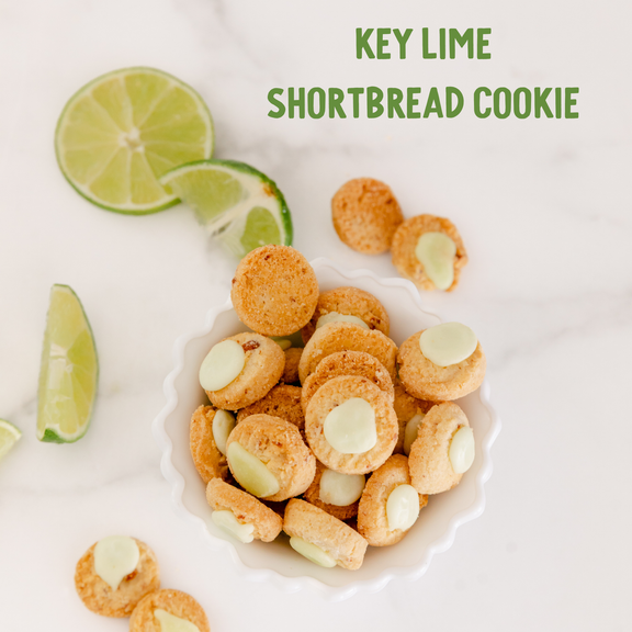 Golden key lime shortbread cookies with white chocolate chips, garnished with fresh lime slices on a white plate