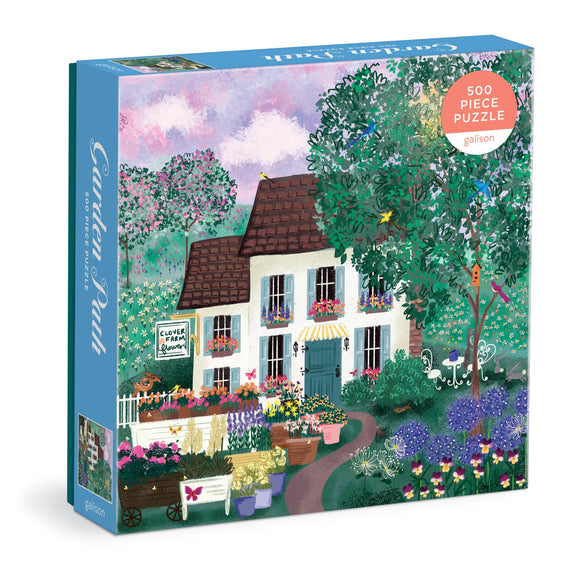 Garden Path 500-piece puzzle box featuring illustrated white cottage surrounded by colorful flowering plants and green foliage.