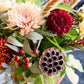 Bouquet of flowers with red, orange, and pink colors against a blurred background