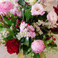 Bouquet of flowers with pink, red, and white flowers on a blurred background