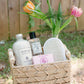 Basket with bath products and flowers on a stand outdoors